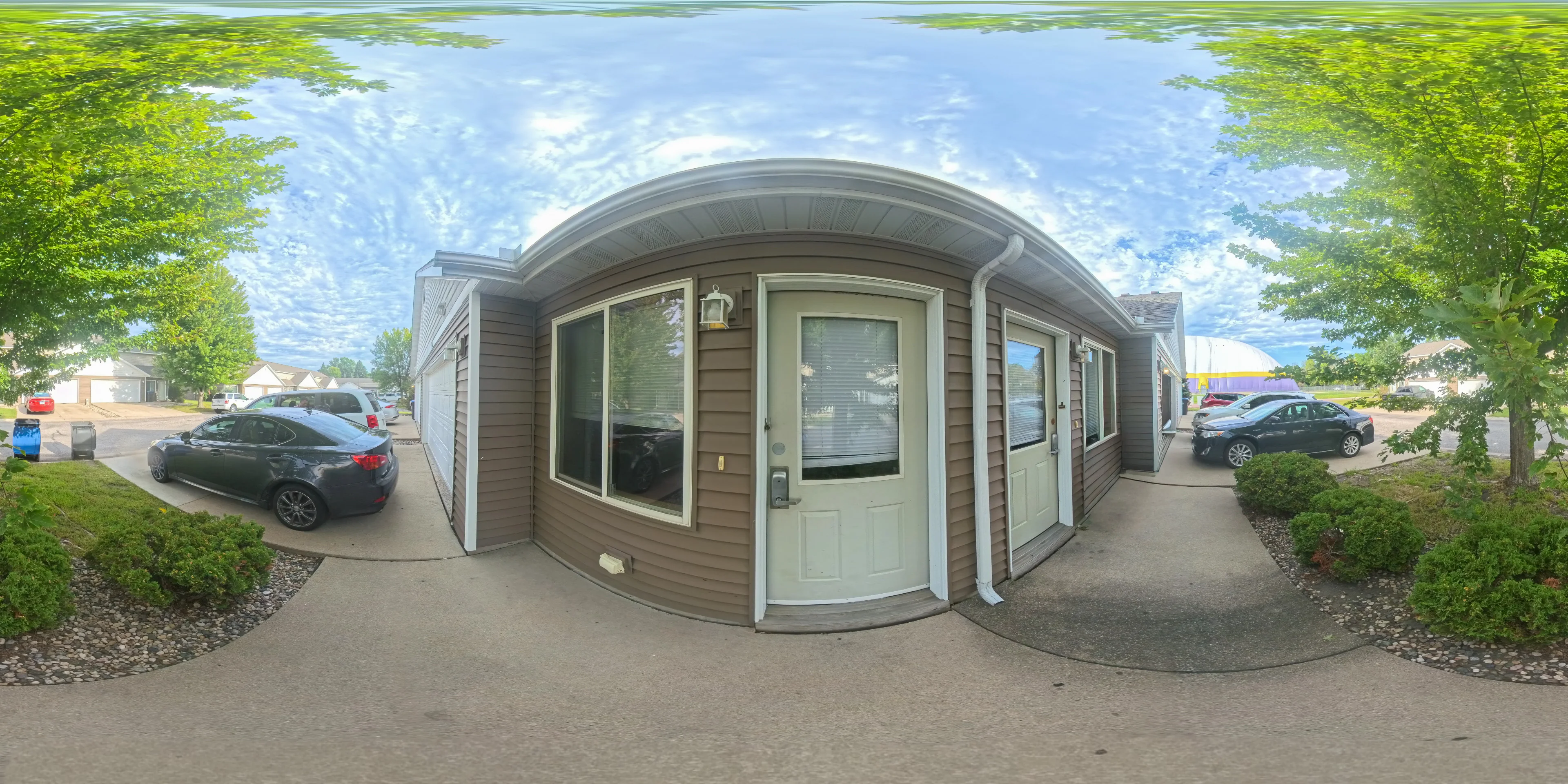 Tree-lined exterior of a Minnesota rental property, captured in 360 degrees
